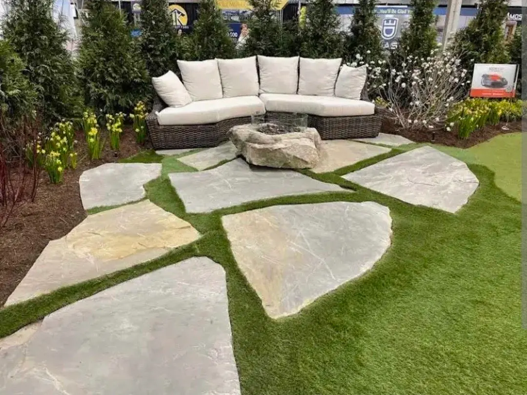 Flagstone patio with grass joints, outdoor seating, and fire feature