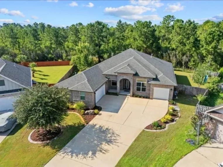 Aerial view of complete front yard landscaping with curved beds and shrubs