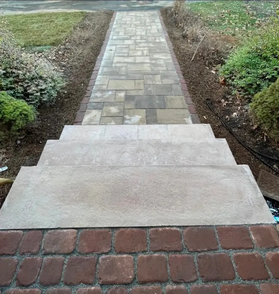 View from porch of paver walkway with natural stone steps and brick border