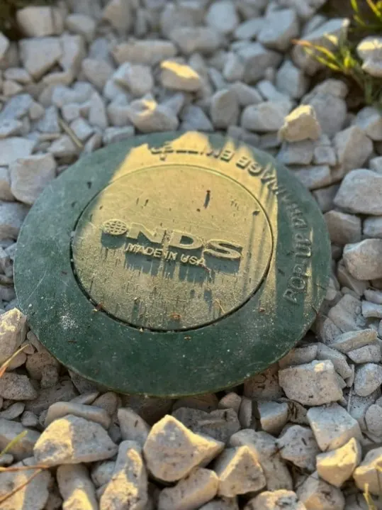 NDS pop-up drainage emitter installed in gravel bed