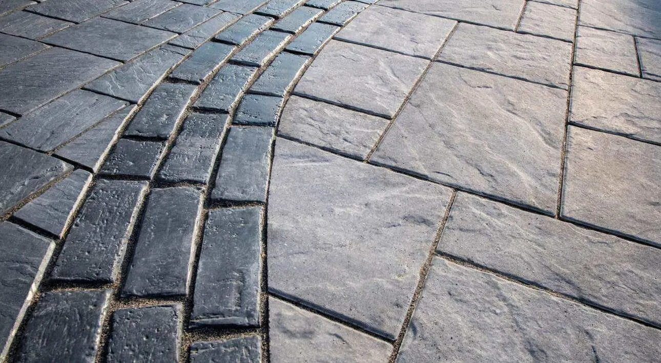 Close-up of multi-tone gray paver pattern with curved brick border