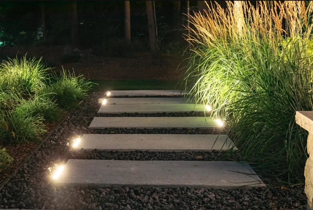 Floating stepping stones with accent ground lights and ornamental grasses